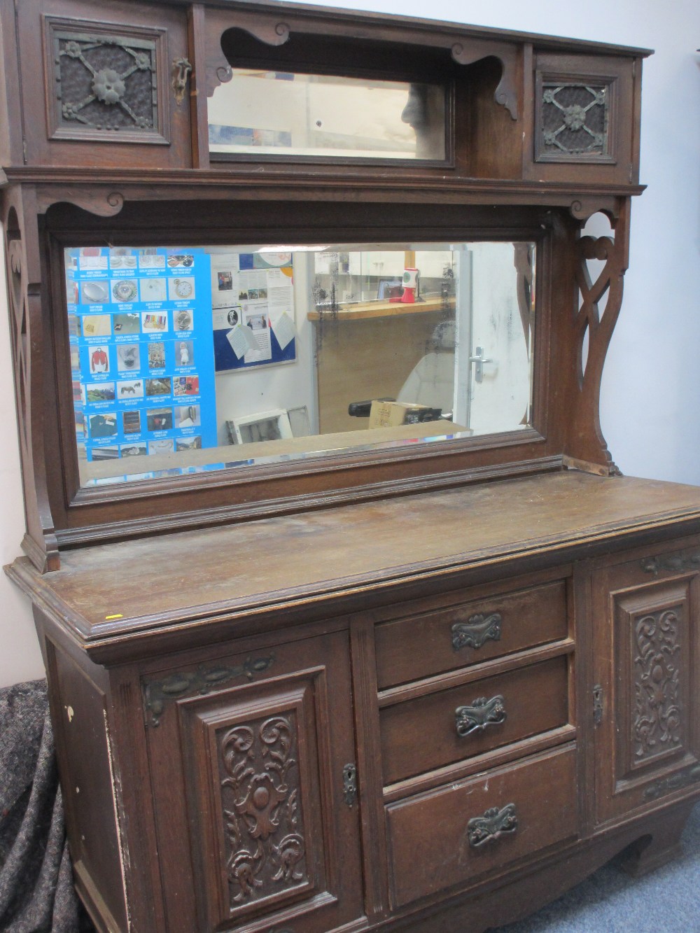 OAK MIRROR BACK SIDEBOARD, circa 1900, having twin cupboard top with central mirrored shelf over a