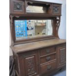 OAK MIRROR BACK SIDEBOARD, circa 1900, having twin cupboard top with central mirrored shelf over a