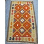 MAIMANA KILIM SINGLE BORDERED RUG - with repeating central diamond pattern in reds and muted