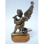 VINTAGE CAR MASCOT- WINGED CHERUB WITH LYRE seated on a wheel, possibly mounted as a mascot, LOZENGE