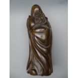 AN ORIENTAL HARDWOOD FIGURE of an old sage 37 cms high