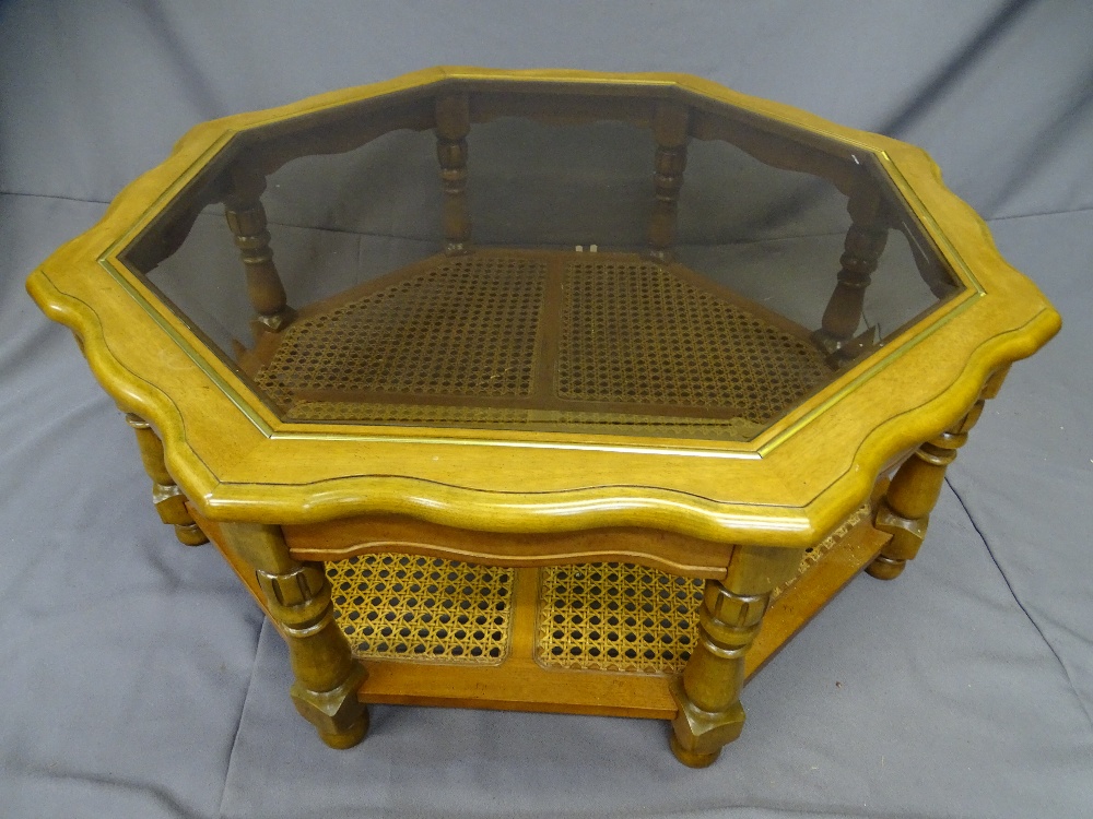 A LARGE MODERN COFFEE TABLE-octagonal with plate glass top and cane shelf base