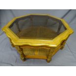 A LARGE MODERN COFFEE TABLE-octagonal with plate glass top and cane shelf base