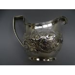SILVER CREAM JUG, oval with scrolled and floral decoration, 4 ounces London 1807.