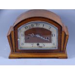 MANTLE CLOCK- a dome topped mahogany and chrome striking clock (damaged areas to dial)