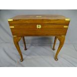 A GENTLEMAN'S LAP DESK- rosewood and brass banded with inset end brass handles. On a purpose made