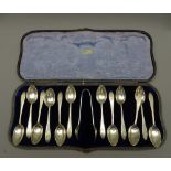 SILVER COFFEE SPOONS, a cased set of 12 with tongs, 4.9 ounces Sheffield 1923
