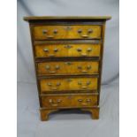 WALNUT REPRODUCTION CHEST of 5 drawers with brass swan-neck handles and on bracket supports, 50cms