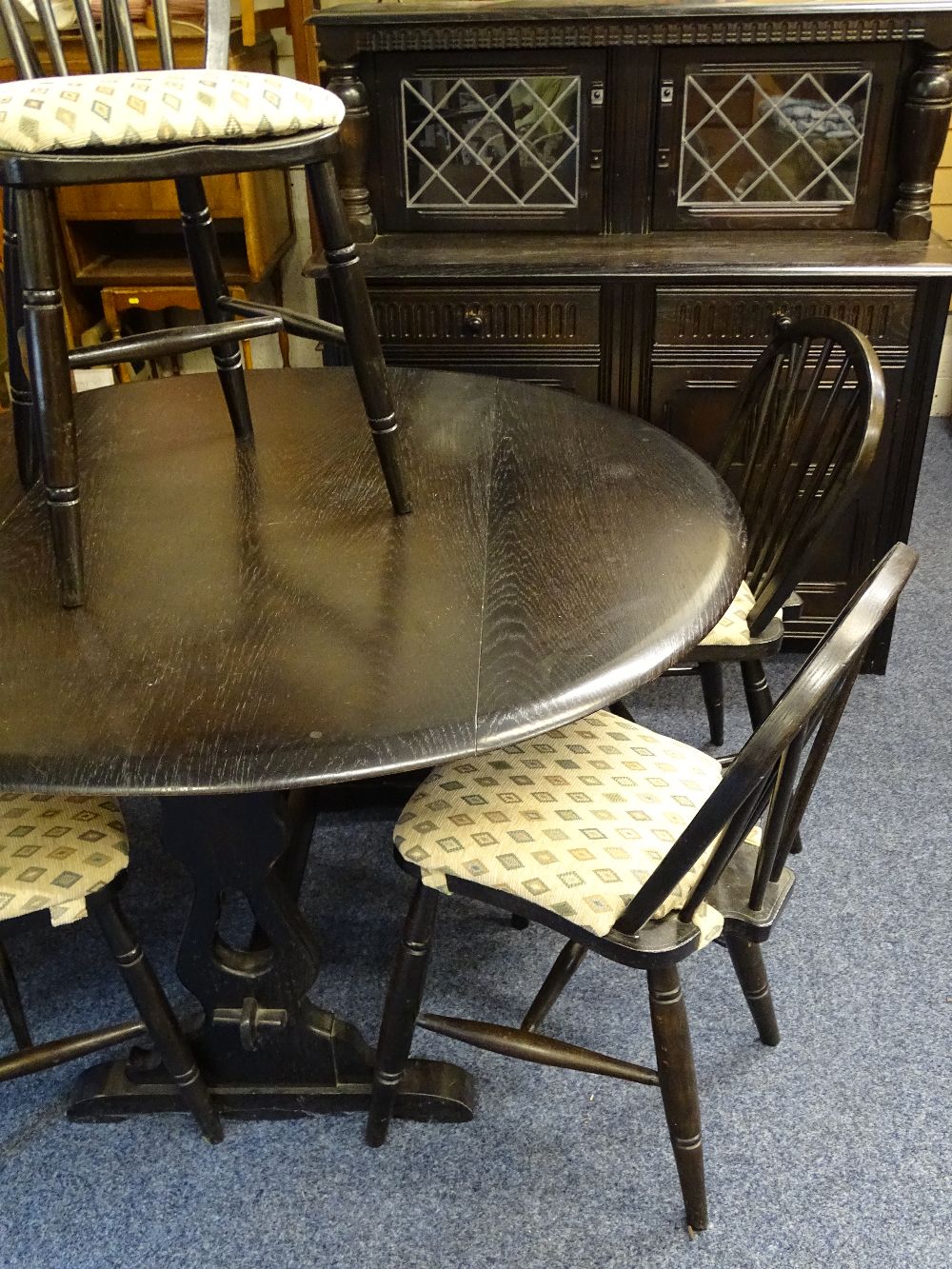 A DINING SUITE - dark wood rustic comprising buffet cupboard and drop leaf dining table with 4