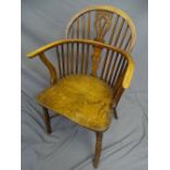 AN ELM WINDSOR CHAIR with crinoline stretcher 90cms high