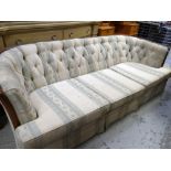 ANTIQUE THREE-SEATER CURVE BACK SOFA with buttoned, striped upholstery, 218cms wide