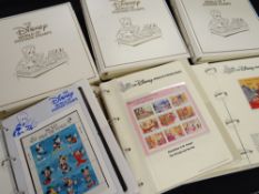 SIX ALBUMS OF THE DISNEY WORLD OF POSTAGE STAMPS published by Inter Governmental Philatelic Corp,