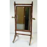 GEORGE IV WALNUT CHEVAL MIRROR on turned supports, fitted with gilt brass telescopic candle holders,