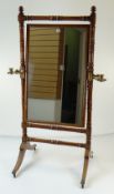 GEORGE IV WALNUT CHEVAL MIRROR on turned supports, fitted with gilt brass telescopic candle holders,