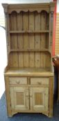 PINE NARROW DRESSER having a base of two drawers and a two-door cupboard, open rack, 86 x 42 x