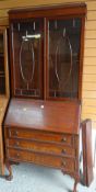 VINTAGE MAHOGANY BUREAU BOOKCASE on ball and claw supports with three drawers and astragal glazed