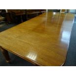 GEORGE IV MAHOGANY EXTENDING DINING TABLE on fluted, reeded corner and centre supports with brass