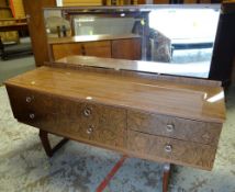 MID-CENTURY FORMICA SIX DRAWER DRESSING TABLE with a wide single pane mirrored top, slightly bowed