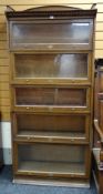 LEBUS OAK FIVE-TIER SECTIONAL GLAZED BOOKCASE, sliding glass fronts with labeled brass