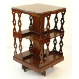 ANTIQUE MAHOGANY REVOLVING BOOKCASE TABLE with shaped top and gothic-style pierced sides, 47 x 47cms