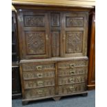 ANTIQUE OAK LINEN PRESS, paneled doors and front later carved with floral decoration on base woth