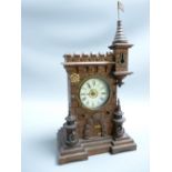 GERMAN MANTEL CLOCK, castellated form with turrets, the enamelled dial set with Roman numerals