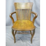 VINTAGE OAK OFFICE ARM CHAIR having curved and slatted back with shaped arms and solid seat on