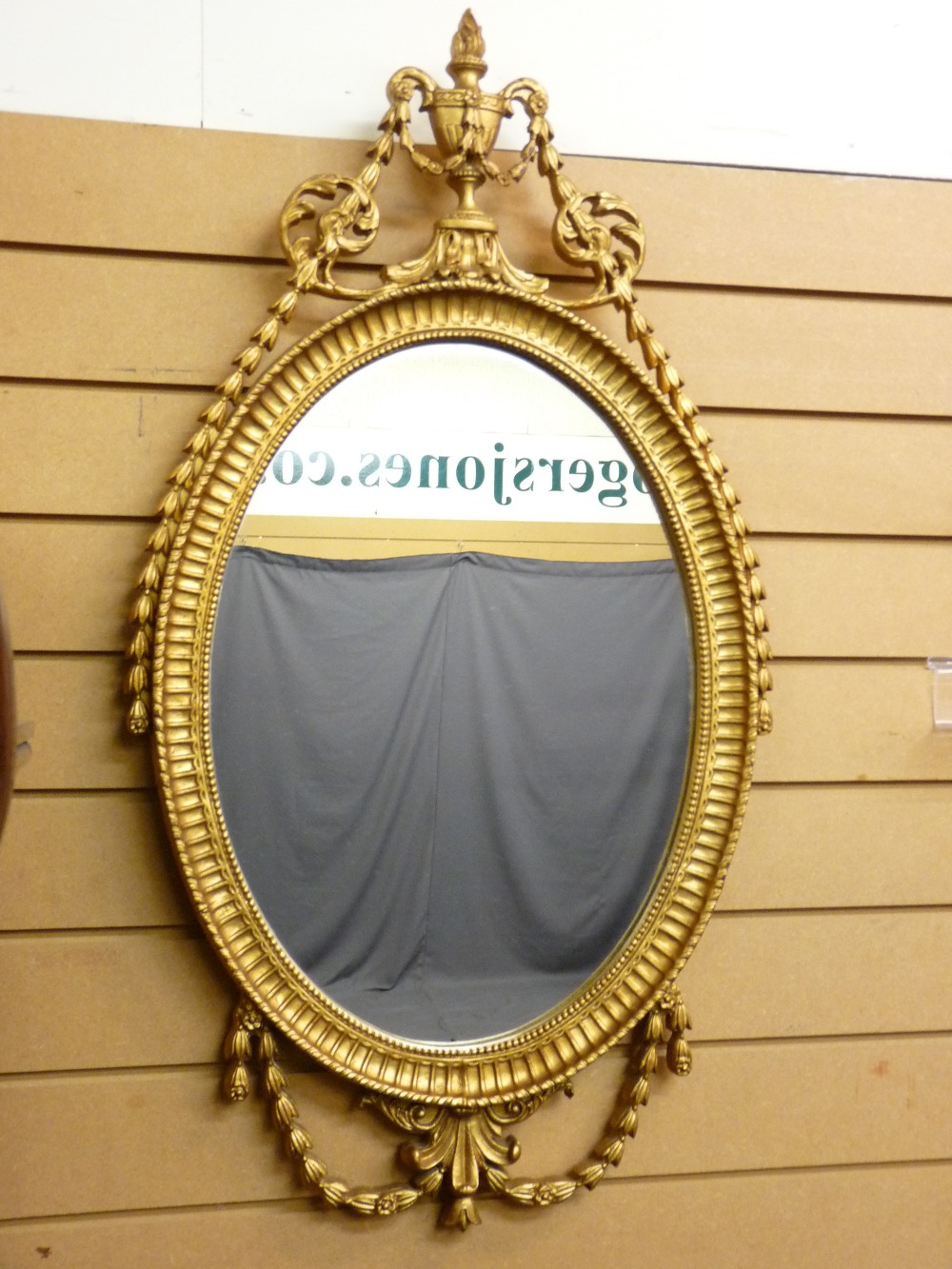 GILT FRAMED WALL MIRROR with urn and swag decoration, 90 x 49cms