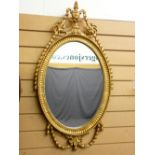 GILT FRAMED WALL MIRROR with urn and swag decoration, 90 x 49cms