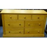 ULTRAMODERN OAK CHEST OF SEVEN DRAWERS WITH TURNED WOODEN KNOBS, 78cms high x 134cms wide x 45cms