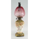 LATE VICTORIAN BRASS MOUNTED OIL LAMP with etched cranberry shade