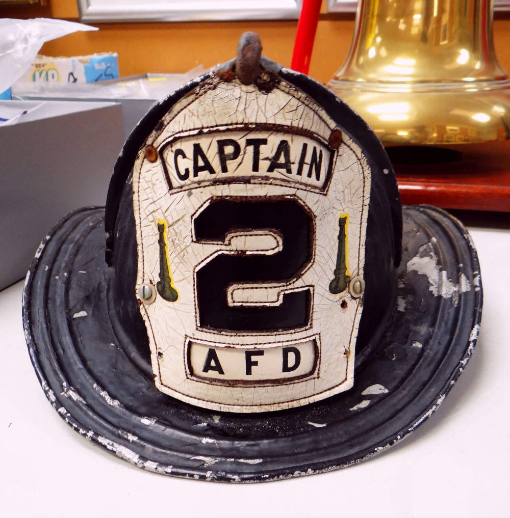 VINTAGE US FIRE FIGHTERS METAL HELMET manufactured by Cairns & Bros (bearing label), the front