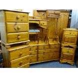 EXTENSIVE ANTIQUE PINE EFFECT SUITE OF BEDROOM FURNITURE to include four door wardrobe, long chest