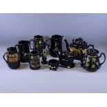 BLACK LUSTRE, a parcel of 9 teaware and other pieces and a black Jackfield oval based cow creamer