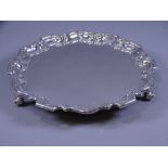 SILVER SALVER, plain form with stepped and wavy rim, on three scrolled feet, 25cms diameter, 17 ozs,