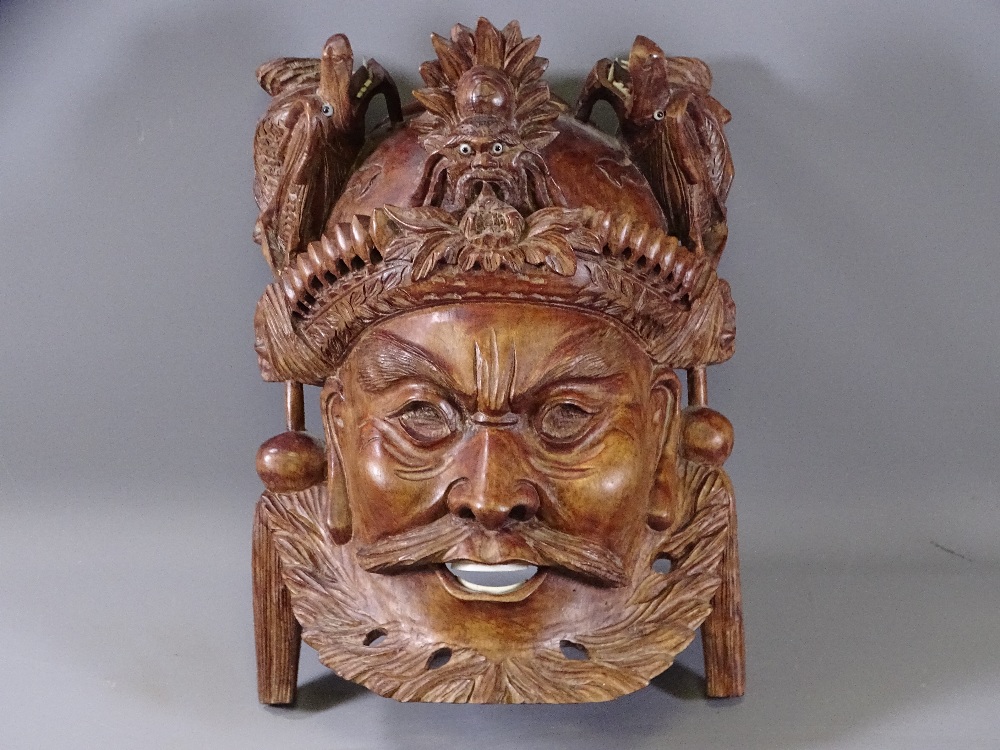 CARVED EASTERN HARDWOOD WALL MASK with dragon detail to the top, 26 x 19cms