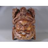 CARVED EASTERN HARDWOOD WALL MASK with dragon detail to the top, 26 x 19cms