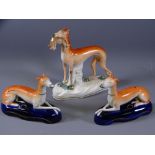 STAFFORDSHIRE GREYHOUND SPILLHOLDERS, a pair, on oval deep blue ground bases and a standing