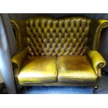 VINTAGE BUTTON UPHOLSTERED WING BACK TWO SEATER SETTEE, green leather effect with studded detail,