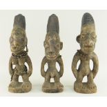 THREE YORUBA IBEJI FIGURES with beaded ornaments, 34cms high (3)