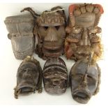 SIX WOBE-GERE MASKS including some with fetish bundles and fibre assemblages (6)