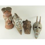 TWO MARKA MASKS each with cut aluminium decoration, 54cms and two Tchokwe masks, 43 & 39cms high (