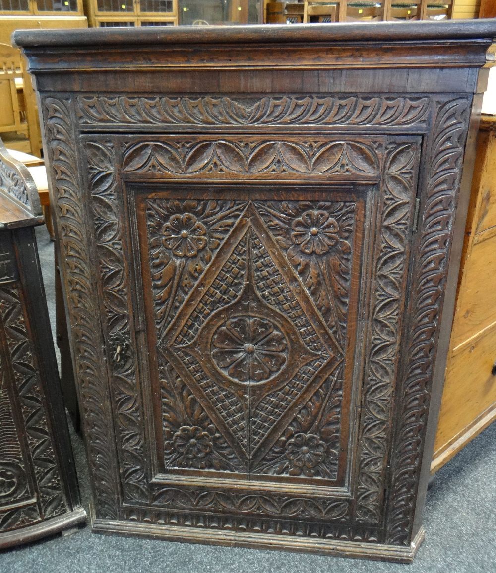 18TH CENTURY CARVED OAK HANGING CORNER CUPBOARD, 80cms high