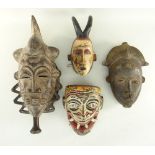 THREE BAULE MASKS including one with painted details and a Sri Lankan polychrome Hanuman mask (4)