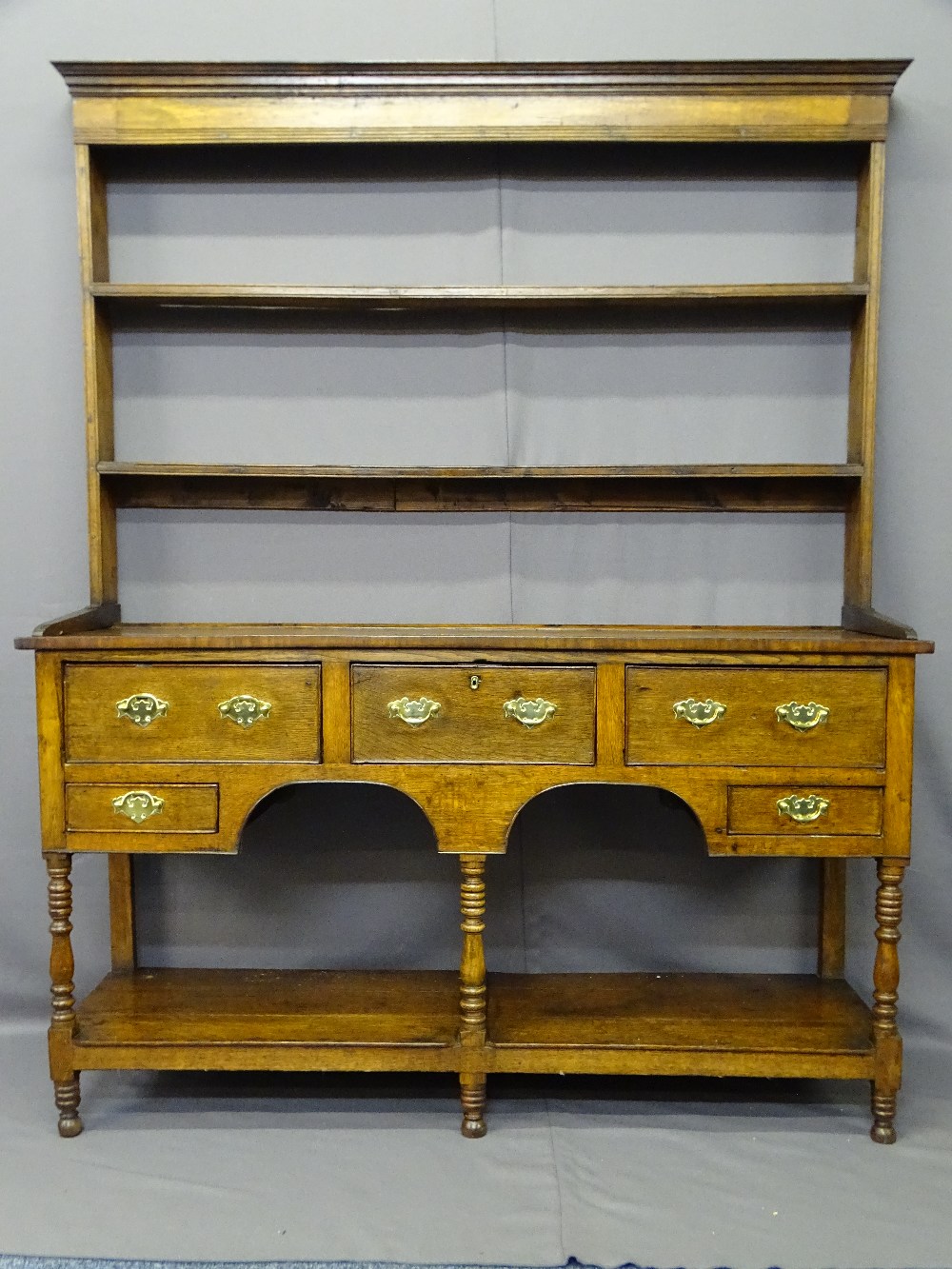 SHROPSHIRE OAK POTBOARD DRESSER, having two shelf open back rack with elongated shoes over a base