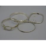 FOUR SILVER BANGLES to include square hinged example, total 1.6 troy ozs