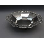 SILVER OCTAGONAL FRUIT BOWL with pierced rim and on four raised feet, 317grms, 23cms, 1931