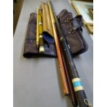 THREE SNOOKER CUES, a tin carry case and one other with a gent's brown leather effect suit