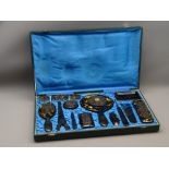 CHINESE TWELVE PIECE TORTOISESHELL DRESSING TABLE SET in original silk lined box, c1920, with carved