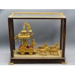 CARVED WOOD INDIAN DISPLAY depicting a horse drawn carriage, cased (glass missing)